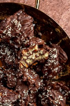 chocolate covered desserts in a metal bowl on a table