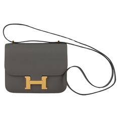 Hermes mini constance cross body 18cm in gris meyer epsom leather and gold tone hardware. Date stamp B for 2023. Shoulder strap drop 20". Comes with felt, original dustcover and box. Mini Constance Hermes, Mini Constance, Luxury Bags Collection, Date Stamp, Hermes Constance, Fashion Handbags, Purses Crossbody, Luxury Bags, Cross Body