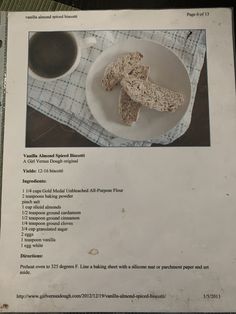 a white plate topped with food next to a cup of coffee on top of a table