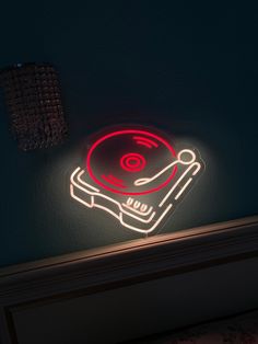 a dj turntable sitting on top of a table next to a wall mounted light