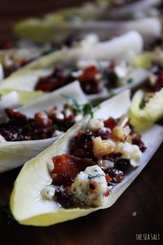 several pieces of artichoke with cranberry sauce and other toppings on them