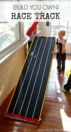 two children are playing with a race track