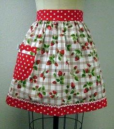 a mannequin wearing a red and white polka dot skirt with strawberry print on it