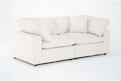 a white couch with pillows on top of it