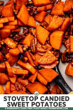 chopped up sweet potatoes and pecans on a cutting board with a wooden spatula