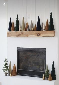 a fireplace with christmas trees on the mantel