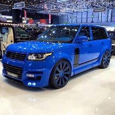 the blue range rover is on display at an auto show