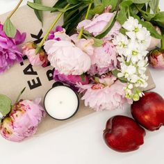 flowers, candles and apples on a table