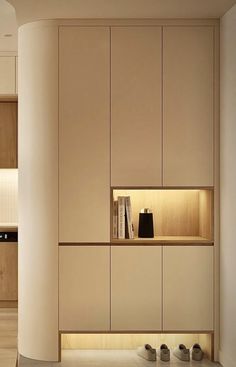 an empty room with some books on the shelf and other items in the cabinet space