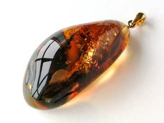 "Such an exquisite amber piece - intense and dark brown color unique drop/ oval shape pendant with natural golden details inside. The color scheme is quite dark, yet since it has many light rays inside, this pendant brings a positive outlook towards life. Needless to say its high quality shines as bright as little rays of sun and uplifts the mood. MATERIALS AND SIZE: Stone: 100% Natural Baltic Amber Other materials: silver 925 gold plated Weight: 9,4 g (0,33 oz) Pendant size: 4,5 cm (1,77 in) x Cognac Color, Light Rays, Natural Amber, Dark Brown Color, Positive Outlook, Oval Pendant, Baltic Amber, Resin Jewelry, Color Scheme