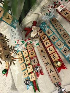 some scrabbles are laying on a table with christmas decorations and other items