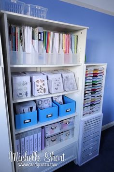 the shelves are filled with many different types of cards and envelopes in blue bins