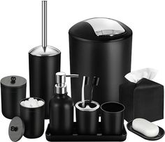 black bathroom accessories including soap dispenser, toothbrush holder and toilet brush