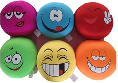 four different colored balls with faces drawn on them