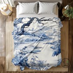 a bed covered in a blue and white comforter