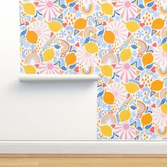 the wallpaper is colorful and has an abstract pattern with hearts, lemons, and sunbursts on it