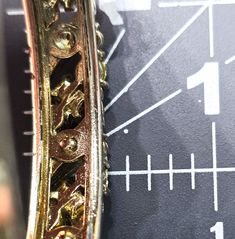 a close up view of a gold clock face