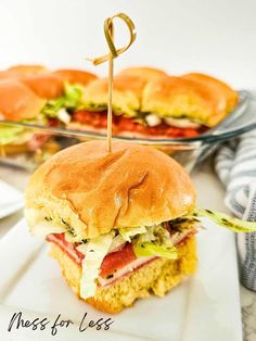 a close up of a sandwich on a plate with a toothpick in it