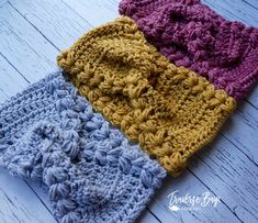 three crocheted headbands laying on top of each other