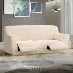 a white couch sitting on top of a hard wood floor