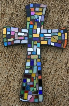 a cross made out of multicolored glass tiles