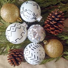 some white and gold christmas ornaments on a table