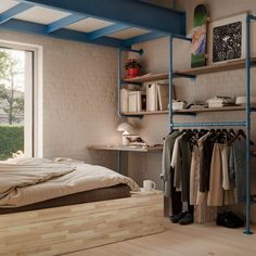 a bedroom with a bed, shelves and clothes on the rack in front of a window