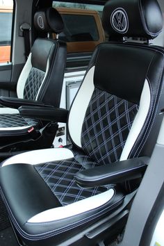 the interior of a vehicle with black and white leather seats