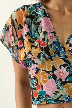 Floral-print chiffon blouse. V neckline. Short kimono sleeves. Open back with tie closure. Smocked elastic-back waist. Cropped length. Sleeveless lining. Relaxed fit. 100% Polyester. Imported. Designed in LA. Model wears size S. Summer Floral Print Blouse With Kimono Sleeves, Summer Blouse With Floral Print And Kimono Sleeves, Floral Print Blouse With Kimono Sleeves For Summer, Floral Print Chiffon Blouse For Vacation, Floral Print Chiffon V-neck Top, Chiffon Floral Print Blouse For The Beach, Chiffon V-neck Blouse For Vacation, V-neck Chiffon Blouse For Vacation, Multicolor Smocked Back Summer Blouse