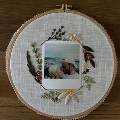 a couple kissing in the middle of a embroidery hoop