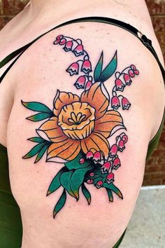 a woman with a flower tattoo on her shoulder