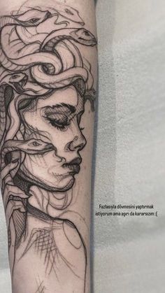 a woman's face with an intricate pattern on her forearm and arm, in black ink