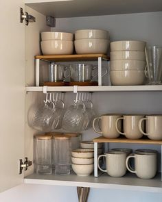 the shelves are filled with dishes and cups