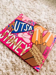 a close up of a piece of art on a carpet with the words utsa and an ice cream cone