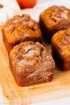 some cinnamon rolls are on a cutting board