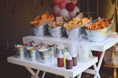 several buckets filled with food sitting on top of a table