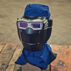 a helmet and goggles on top of a wooden table