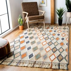 a living room with a chair, rug and potted plants