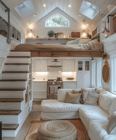 a living room filled with furniture under a loft