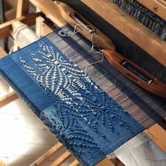 a close up of a piece of cloth on a table next to a pair of scissors