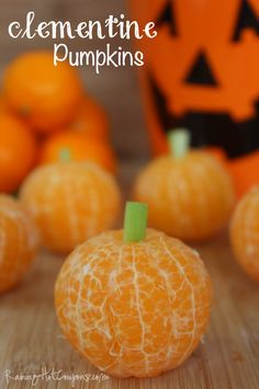 some oranges are sitting on a table next to an orange canister and jack - o'- lanterns