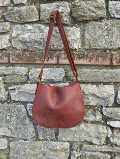 Cognac leather crossbody bag, This bag is a medium size classic crossbody bag. This bag is unlined.  The bag is closed by a magnetic button. This bag you can take every where in any occasion Features : - Cognac leather, - Brass finishing, - Unlined. Size :  - Width 10.2 inch, - Height 8.2 inch, - Adjustable shoulder belt length max 45 inch. If you want to add a boho touch to your bag, buy a suede tassel separately use this link  https://www.etsy.com/it/listing/1524528378/nappina-portachiavi-in-pelle-scamosciata?click_key=7fb2fd2620a322dc68df4e06dd903348ab88127c%3A1524528378&click_sum=bae350f5&ref=hp_opfy-4&frs=1 Contact me for any information                --------------------------------------- The shipping is made after 10 days by the purchase with express courier.                 ----- Cognac Textured Leather Satchel Shoulder Bag, Cognac Textured Leather Shoulder Satchel, Textured Leather Saddle Bag, Classic Brown Crossbody Hobo Bag, Leather Saddle Shoulder Bag With Textured Leather, Cognac Saddle Bag With Leather Lining For Everyday, Cognac Saddle Shoulder Bag For Daily Use, Everyday Saddle Bags, Classic Textured Leather Crossbody Hobo Bag