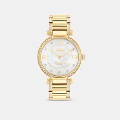 Timeless and elegant the Cary watch is a sophisticated style perfect for day or night. The gold tone bracelet design shimmers with crystals and features a luminous mother-of-pearl dial with our iconic Horse and Carriage motif for a heritage touch. | Coach Cary Watch, 34 Mm - Women's - Gold Elegant Gold-tone Watch With Round Dial, Classic Gold Coach Watch, Gold Coach Watch With Metal Dial, Coach Gold Watch With Metal Dial, Coach Gold Watches With Metal Dial, Coach Timeless Gold Watch, Luxury Coach Watches With Polished Finish, Elegant Gold Coach Watch, Luxury Coach Watches With Diamond Hour Markers