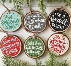 six handmade christmas ornaments hanging from a tree branch with words on them and saying, it's a beautiful time to bake