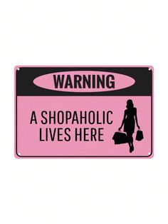 a pink and black warning sign stating that shopaholic lives here