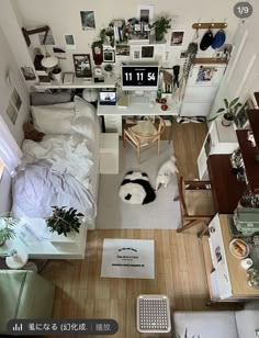 an overhead view of a bedroom with a bed, desk and computer area in it