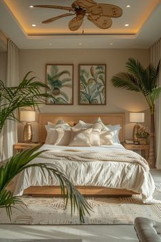 a large bed sitting under a ceiling fan in a bedroom