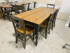 a table and chairs in a room that is being worked on with some woodworking tools