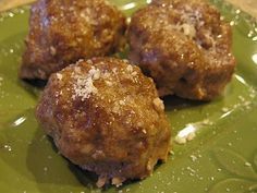 three meatballs sitting on top of a green plate