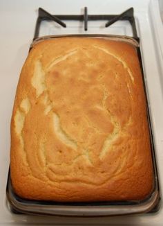 a loaf of bread sitting on top of a metal pan next to a white counter